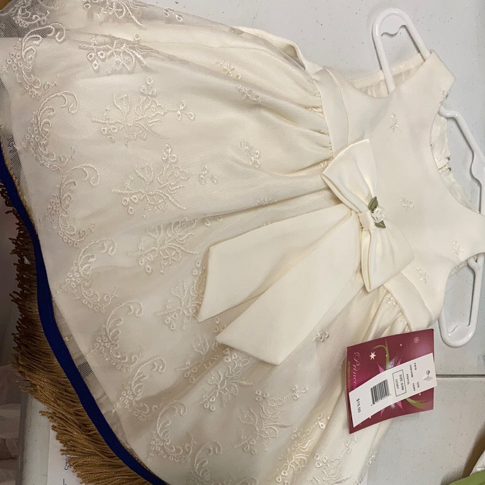 Ivory dress by Princess Faith with fringes. Brand new!